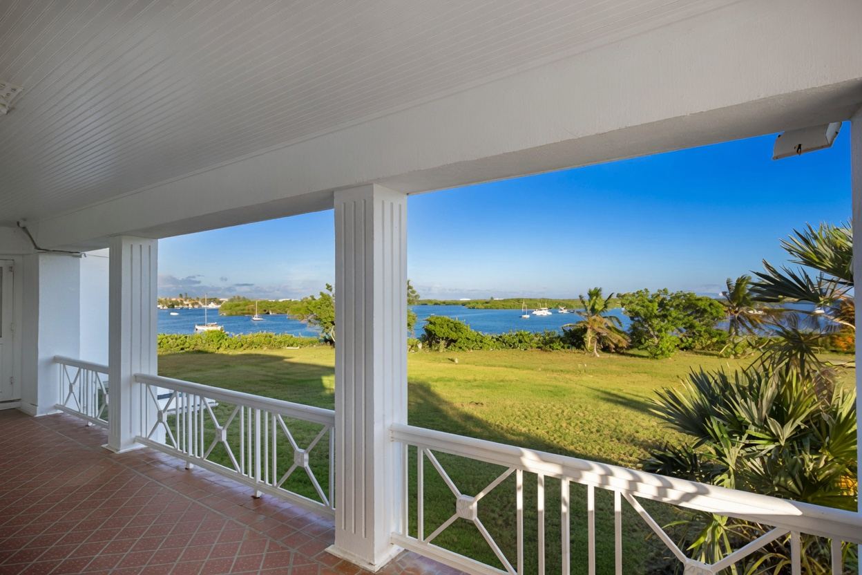Covered waterfront porch with sweeping views of the harbor from Thompson Island